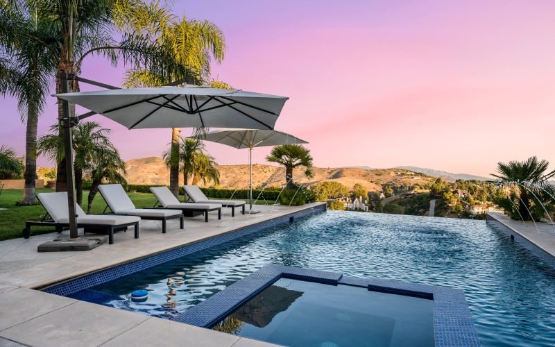 a-beautiful-pool-at-sunset-with-loungers-and-umbre-2025-02-03-13-17-43-utc-scaled-rirrc66wwe6fkdoc241nvykbohlhtx3pha8q0awkug